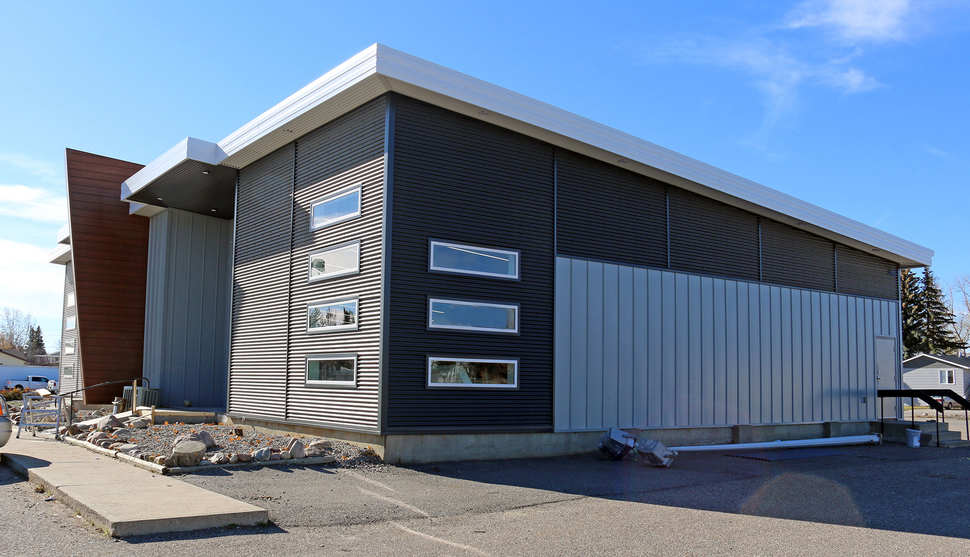 Retail StoreFront featuring Regent Grey Forma Loc Standing Seam Panel, Matte Anthracite 7/8 Corrugated Siding and Espresso Woodgrain Forma Plank Accent