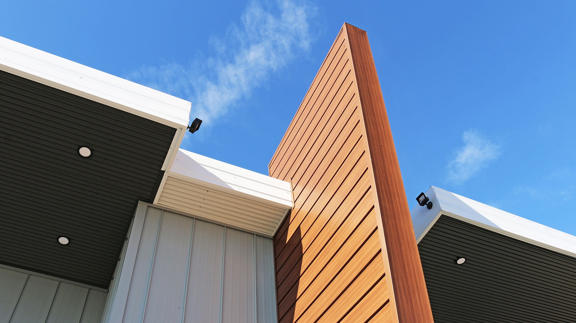 Retail Storefront featuring 7/8 Corrugated Metal Siding and FormaLoc Standing Seam Metal Siding - Forma Steel