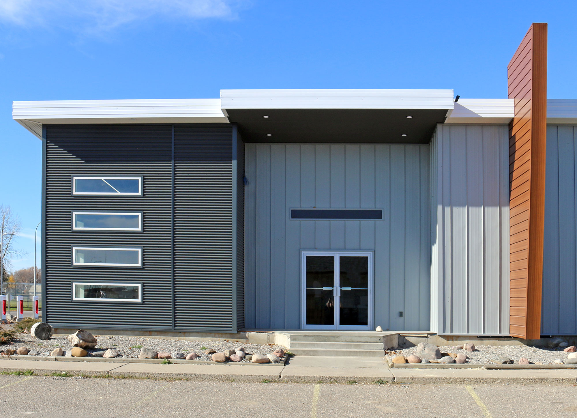Retail StoreFront featuring Regent Grey Forma Loc Standing Seam Panel, Matte Anthracite 7/8 Corrugated Siding and Espresso Woodgrain Forma Plank Accent