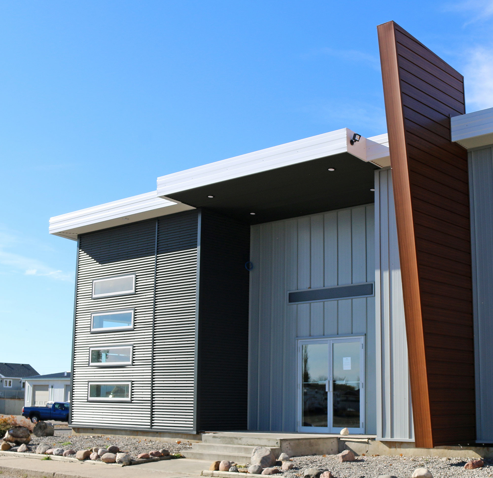 Retail Storefront featuring 7/8 Corrugated Metal Siding and FormaLoc Standing Seam Metal Siding - Forma Steel