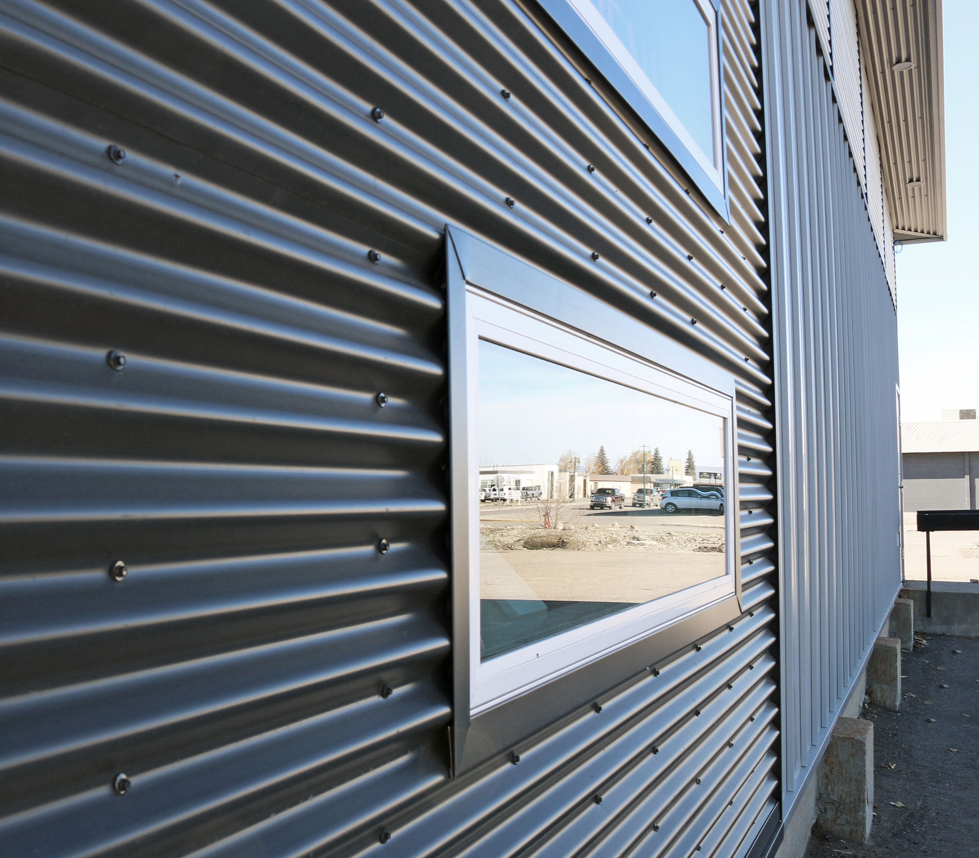 Retail StoreFront featuring Regent Grey Forma Loc Standing Seam Panel and Matte Anthracite 7/8 Corrugated Siding