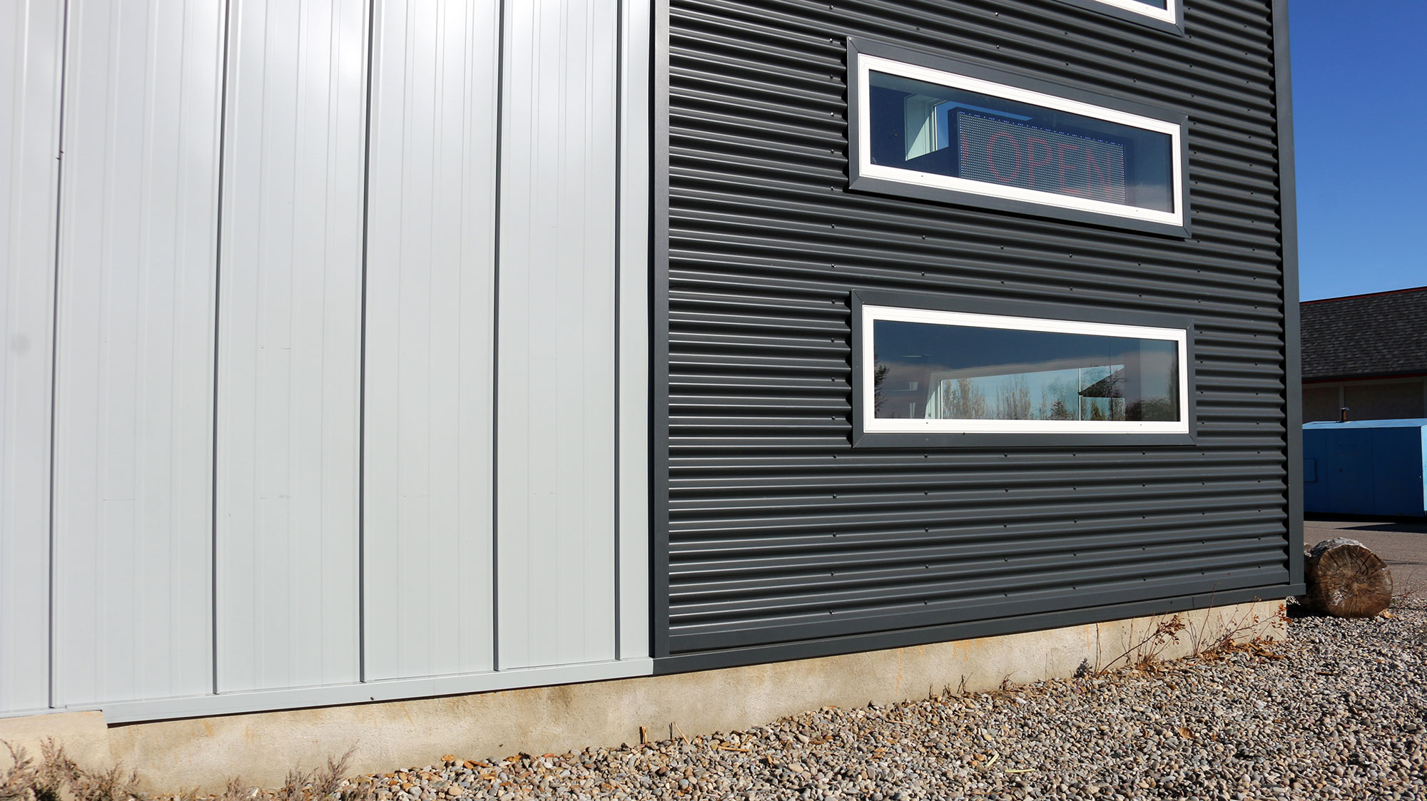 Retail StoreFront featuring Regent Grey Forma Loc Standing Seam Panel and Matte Anthracite 7/8 Corrugated Siding