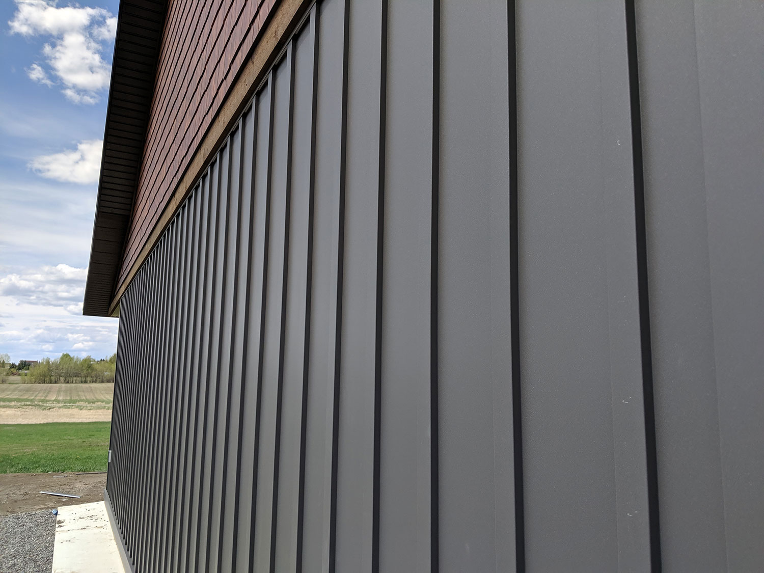 Residential Building with Custom Board and Batten Panels in Graphite FormaTouch Textured Steel