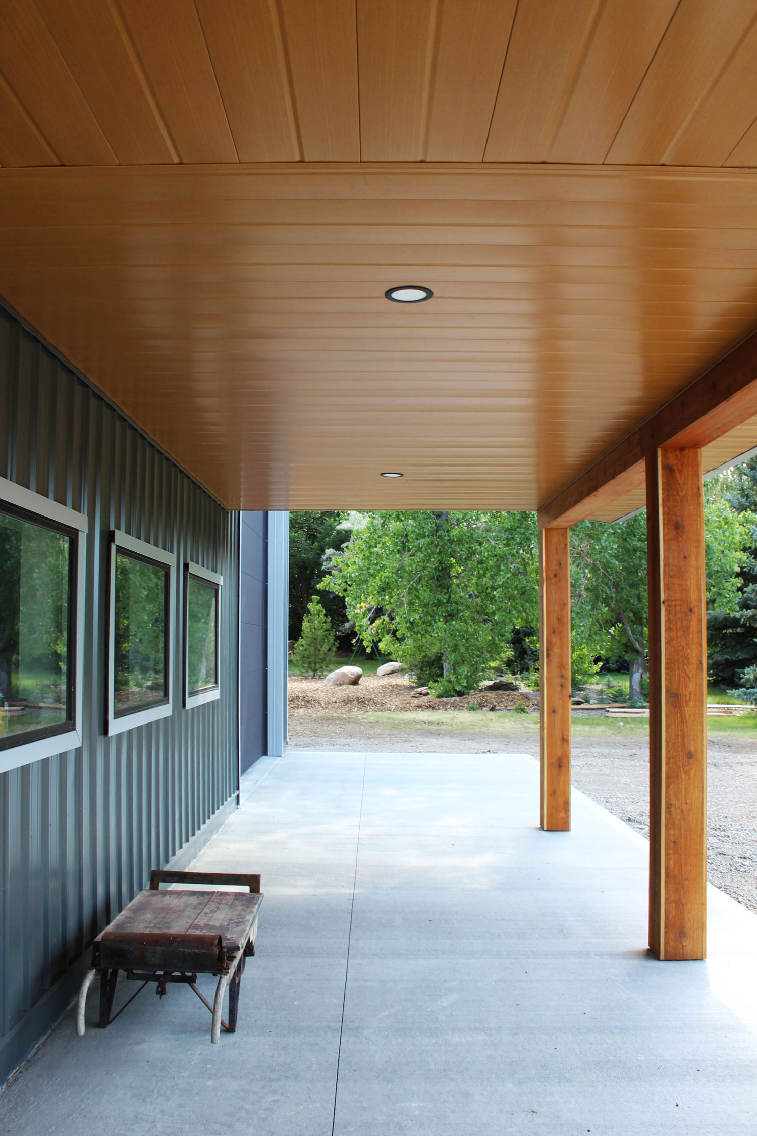 Gunmetal grey siding and Vented Soffit and non-vented soffit in Autumn Woodgrain on a residential work shop