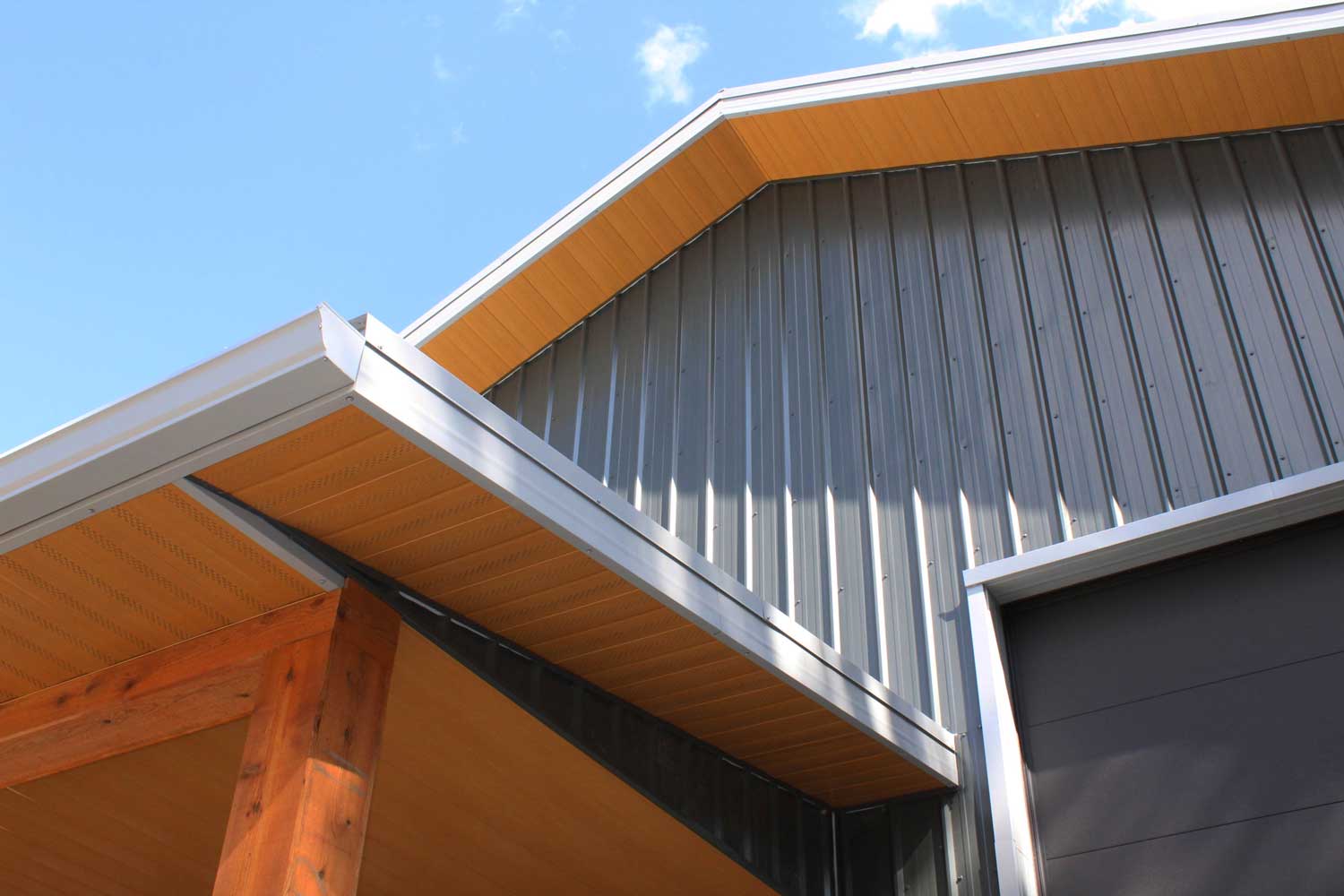 Gunmetal grey siding and Vented Soffit and non-vented soffit in Autumn Woodgrain on a residential work shop