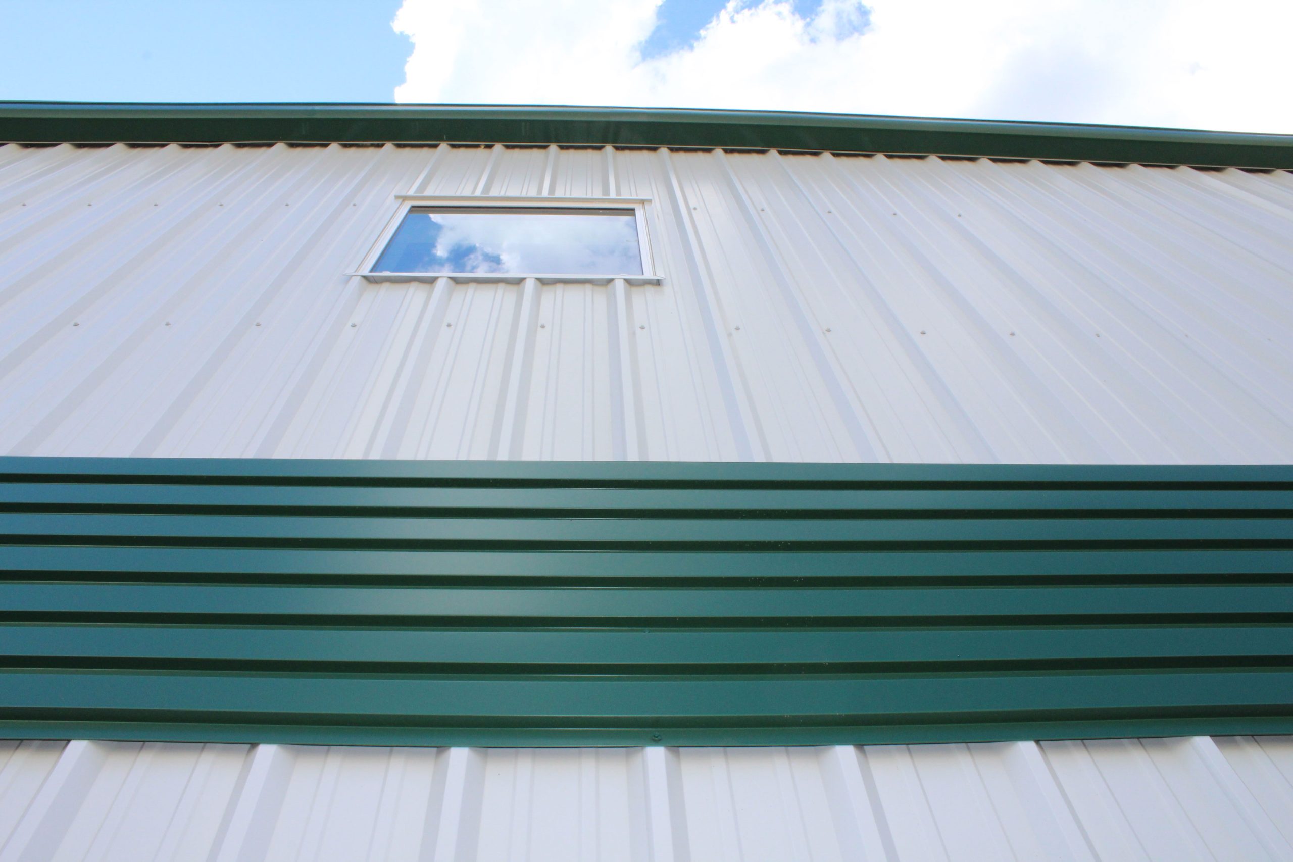 6" Box Rib in Melcher's Green for commercial building Bos Sod. Also includes our Board and Batten panels in Arctic White.