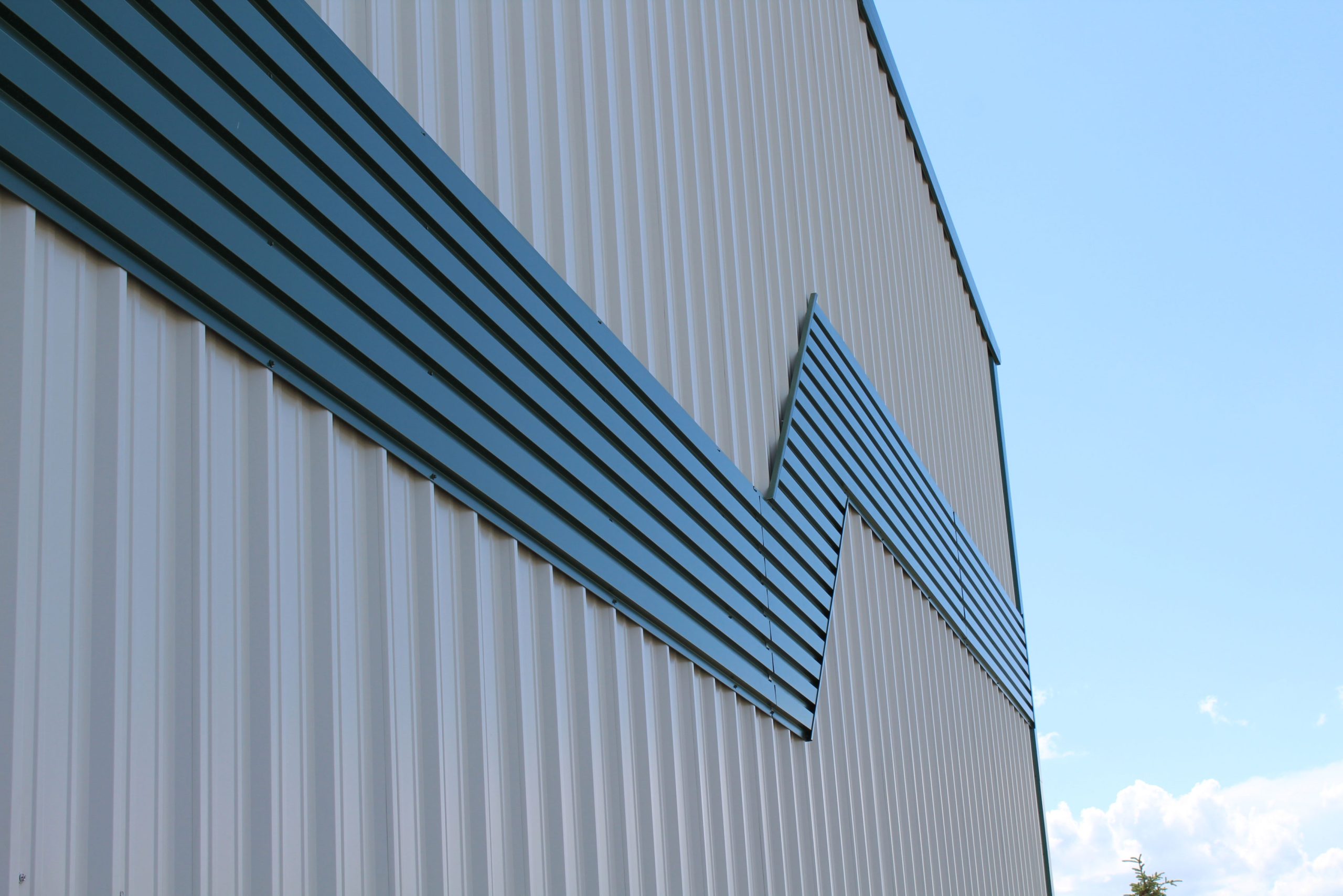 6" Box Rib in Melcher's Green for commercial building Bos Sod. Also includes our Board and Batten panels in Arctic White.