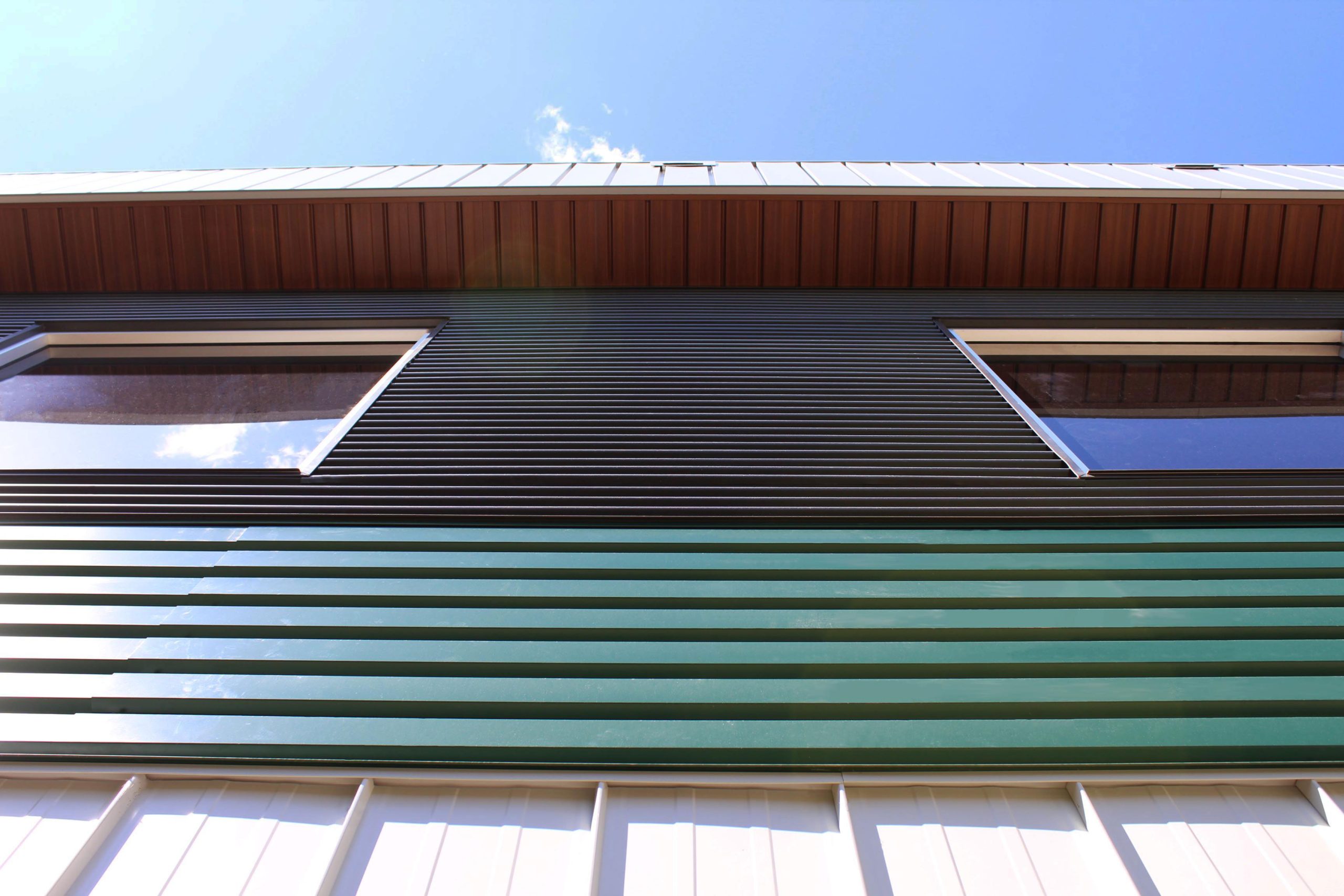 6" Box Rib in Melcher's Green for commercial building Bos Sod. Also includes our Board and Batten panels in Arctic White.